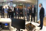 Group of professionals standing in a Liberty Specialty Markets office, listening to a speaker