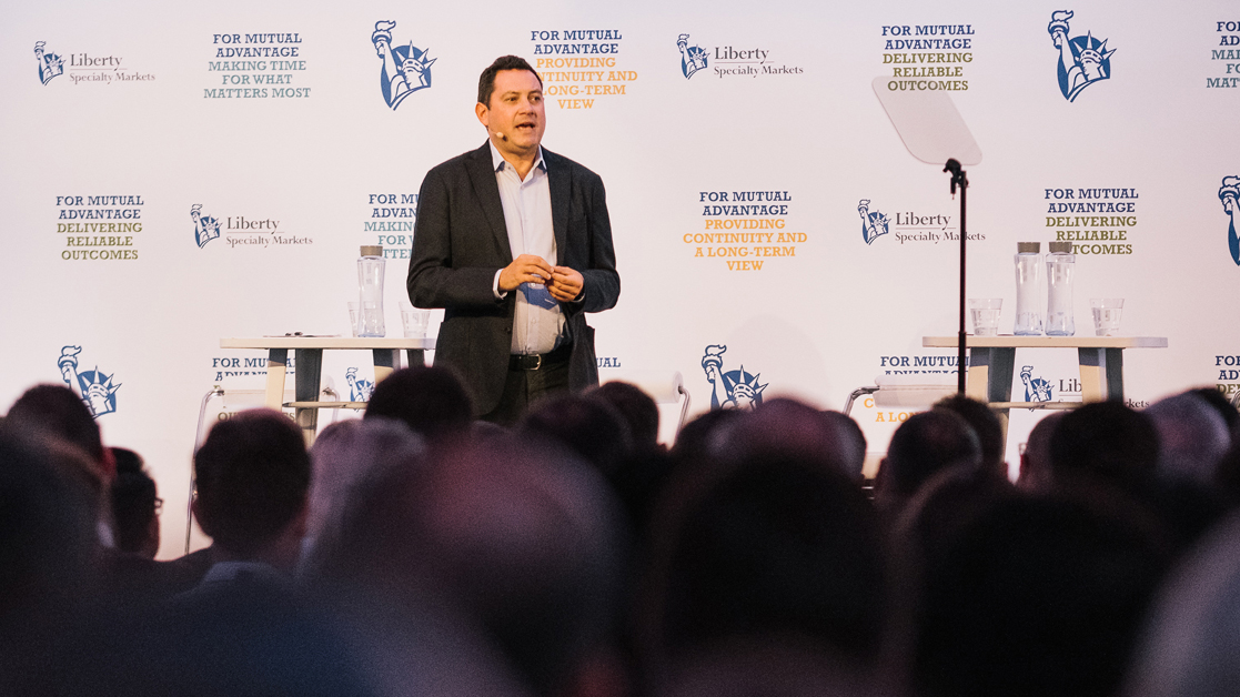 Matthew Moore, President of Liberty Specialty Markets, on stage addressing an audience of employees