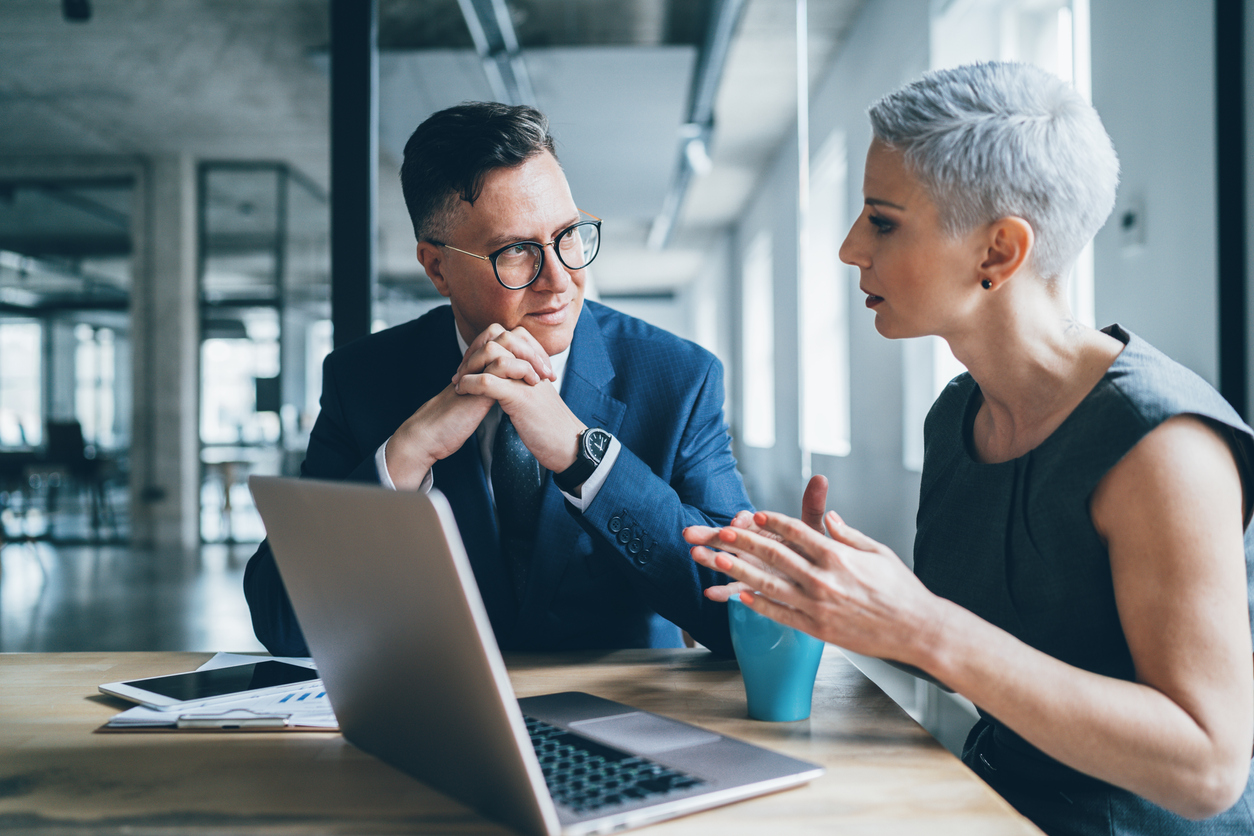 Man and women wearing business wear having a meeting