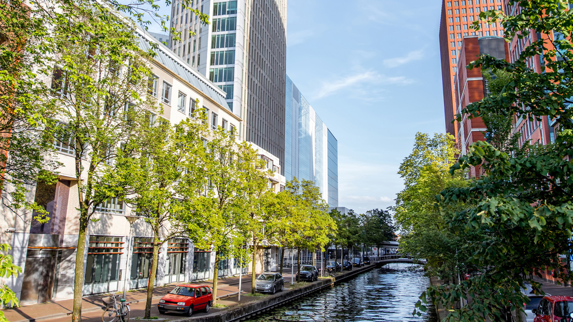 Skyscrapers on either side of the water channel in Haag city, Netherlands