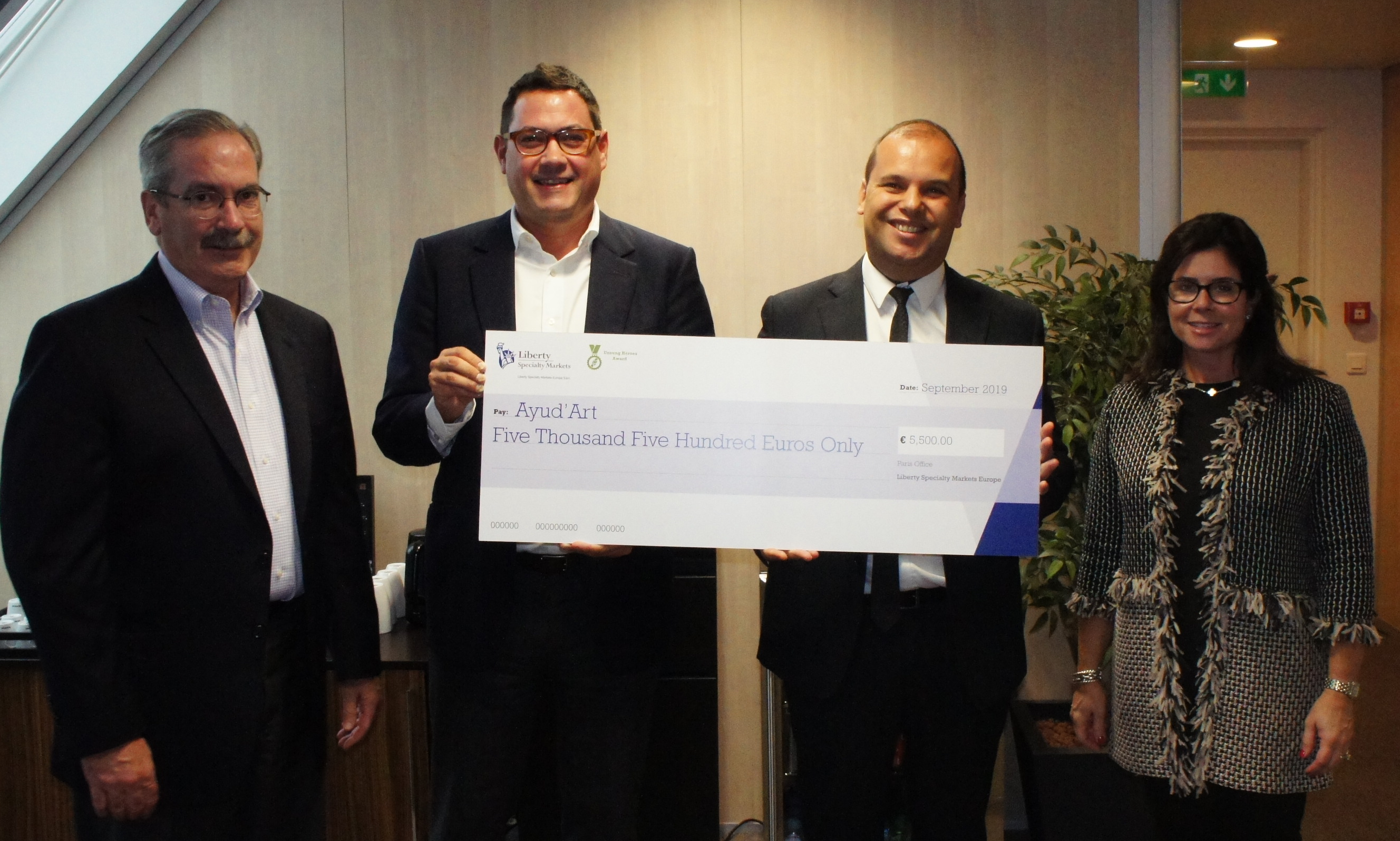 picture of 4 people holding large cheque 