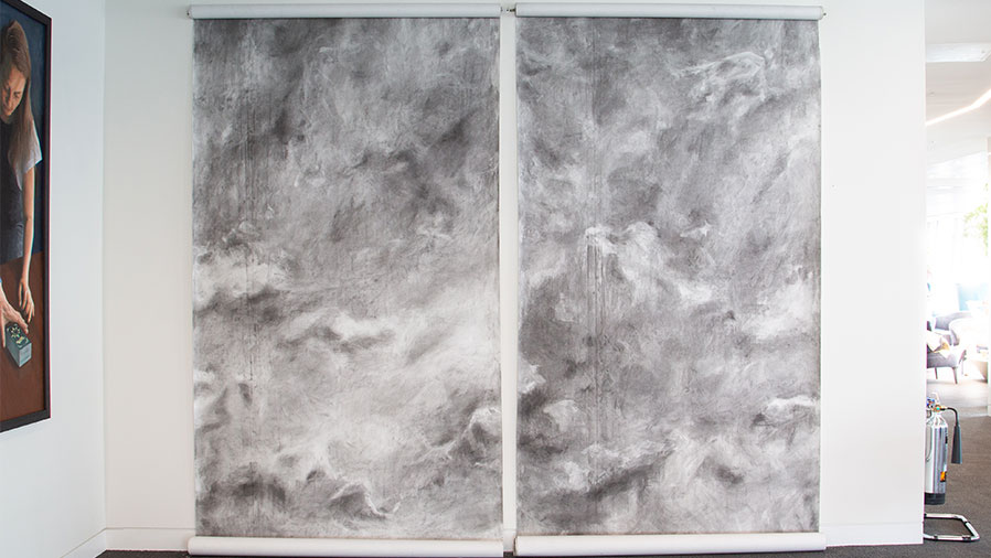 Unrolling the Sky artwork in the office