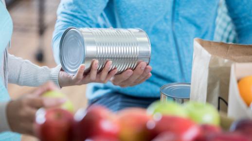 Image of fruit and a person holding a tin can