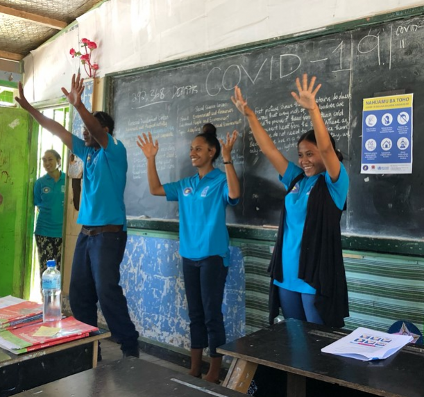 children in classroom smiling