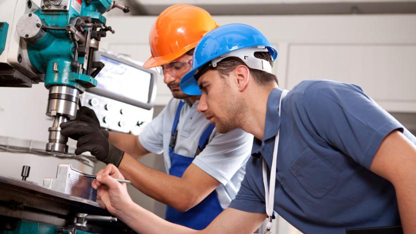 Two engineers with hard hats on