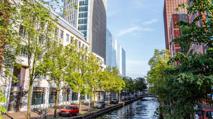 Skyscrapers on either side of the water channel in Haag city, Netherlands