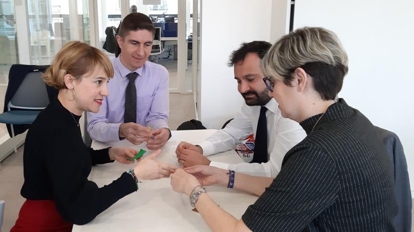 Four Liberty Specialty Markets employees sitting around a table, working together