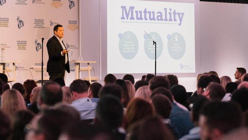 Matthew Moore, President of Liberty Specialty Markets, on stage addressing an audience of employees