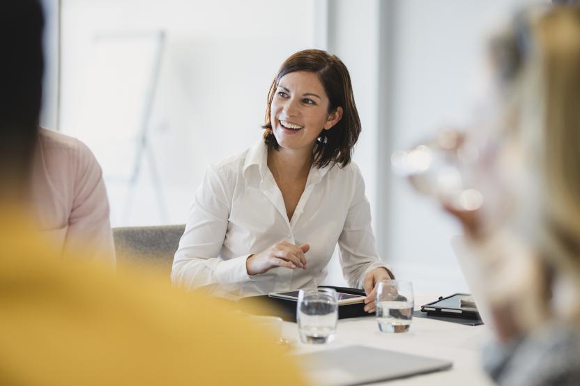 woman smiling at her desk