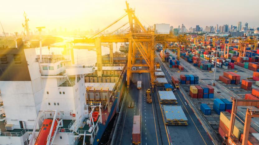 photo of big containers in a shipyard, with a crane 